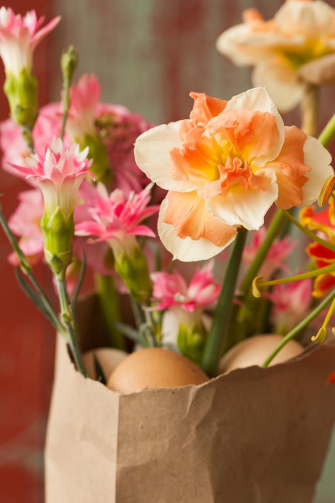 Ranunculus, Gloriosa, Narcissus and Carnation in a paper bag of eggs funnyhowflowersdothat.co.uk