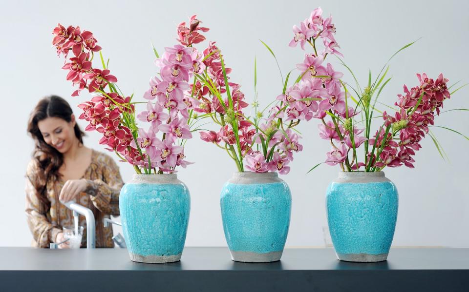 Vases filled with tall, colourful orchids Flower arranging tips for tall vases on funnyhowflowersdothat.co.uk